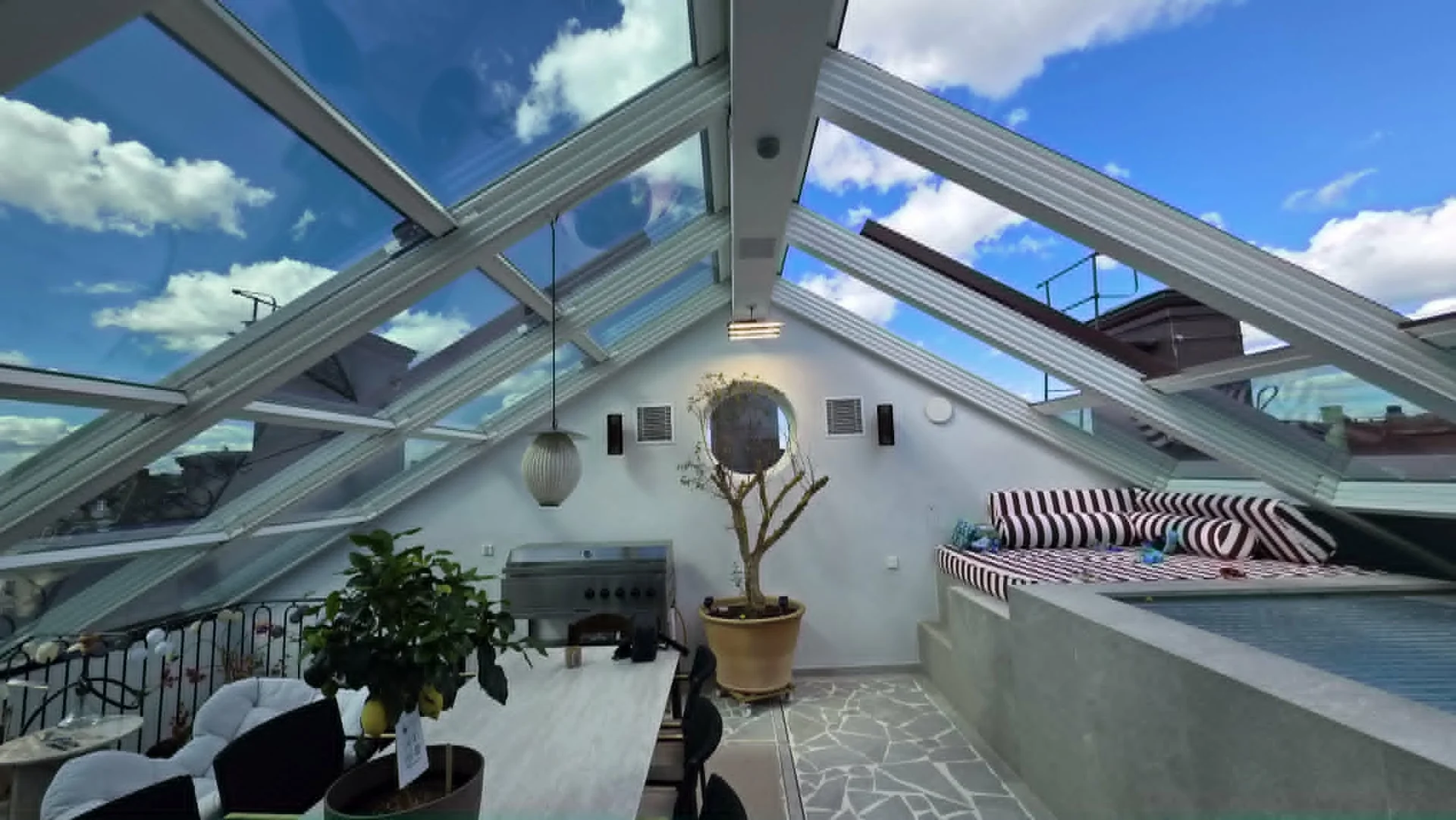 Insulated retractable glass roof viewed from inside with the glazing slid aside